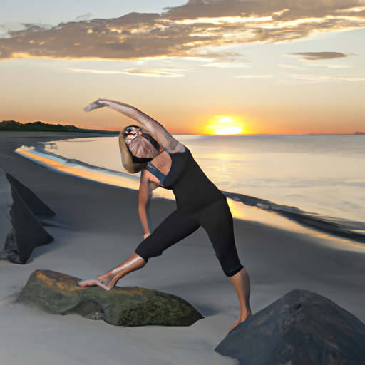 A woman practicing yoga on a beach at sunrise